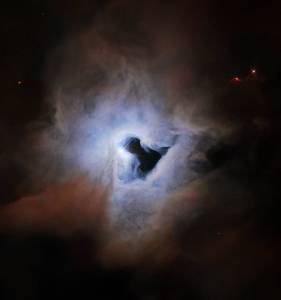 Bright blue-white cloud with a black keyhole-shaped void in the middle. Edge of the blue-white cloud transitions to brownish-rusty colored cloud.