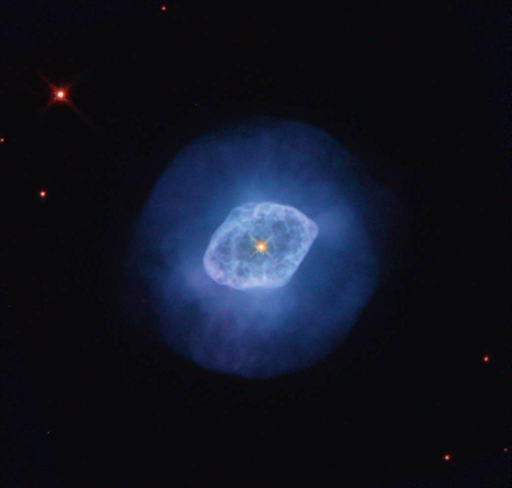 bright blue nebula with a darker blue halo and a bright orange-yellow star at its center