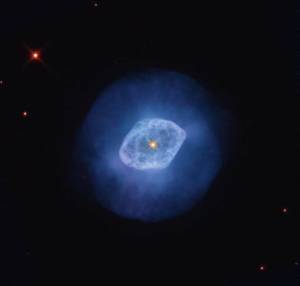 bright blue nebula with a darker blue halo and a bright orange-yellow star at its center