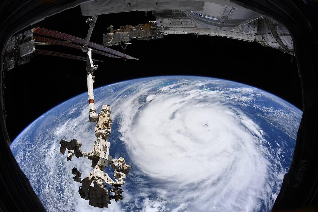 Hurricane Ida as seen from the space station, with space station robotic arm in the foreground. 