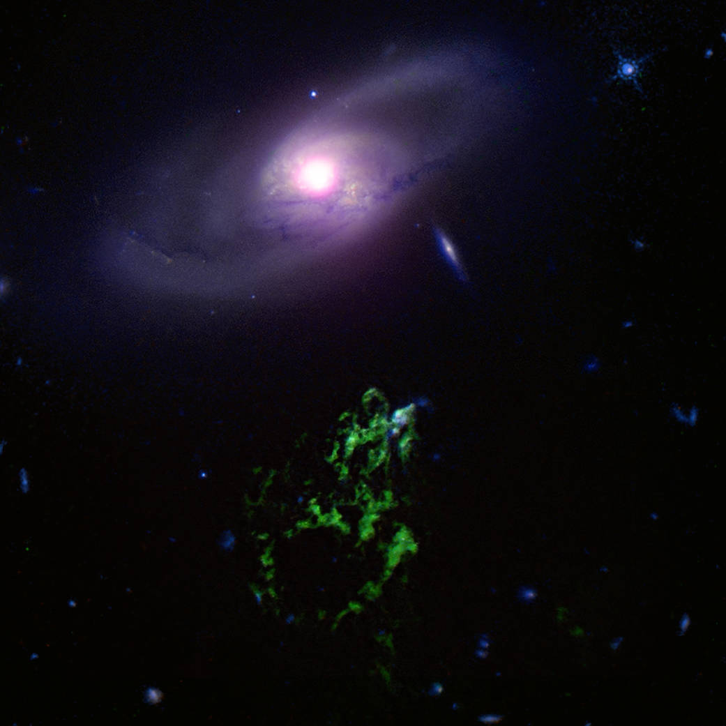 Galaxy IC 2497 and the Green Blob, a renowned cosmic structure also called “Hanny’s Voorwerp” (Dutch for “Hanny’s object”).