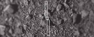 This image depicts the footprint of the Double Asteroid Redirection Test (DART) spacecraft and its two long solar panels over the spot where it impacted asteroid Dimorphos