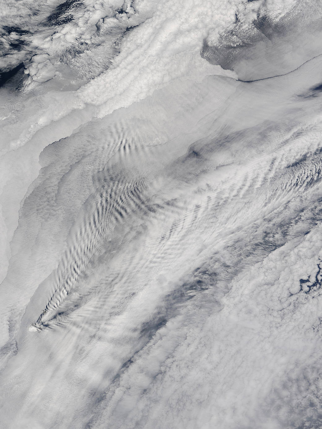 White ship wave shaped clouds over the ocean