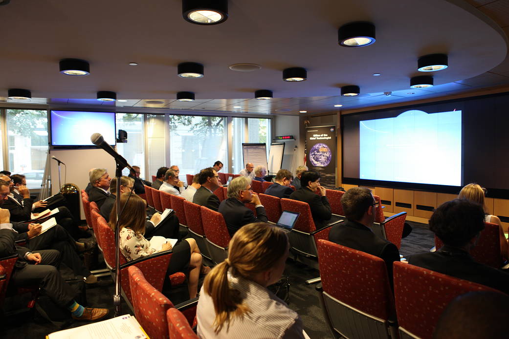 Person talking at podium with people watching