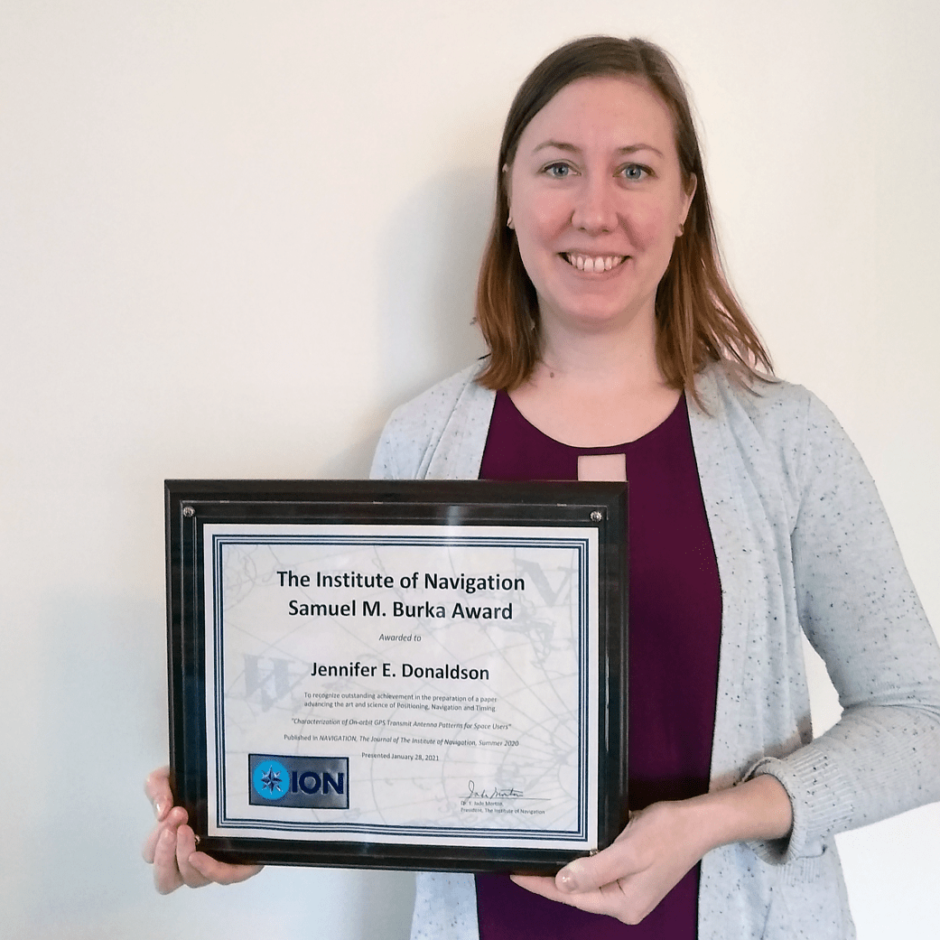 In this photo, GPS ACE engineer Jennifer Donaldson holds the Institute of Navigation's Samuel M. Burka award. 