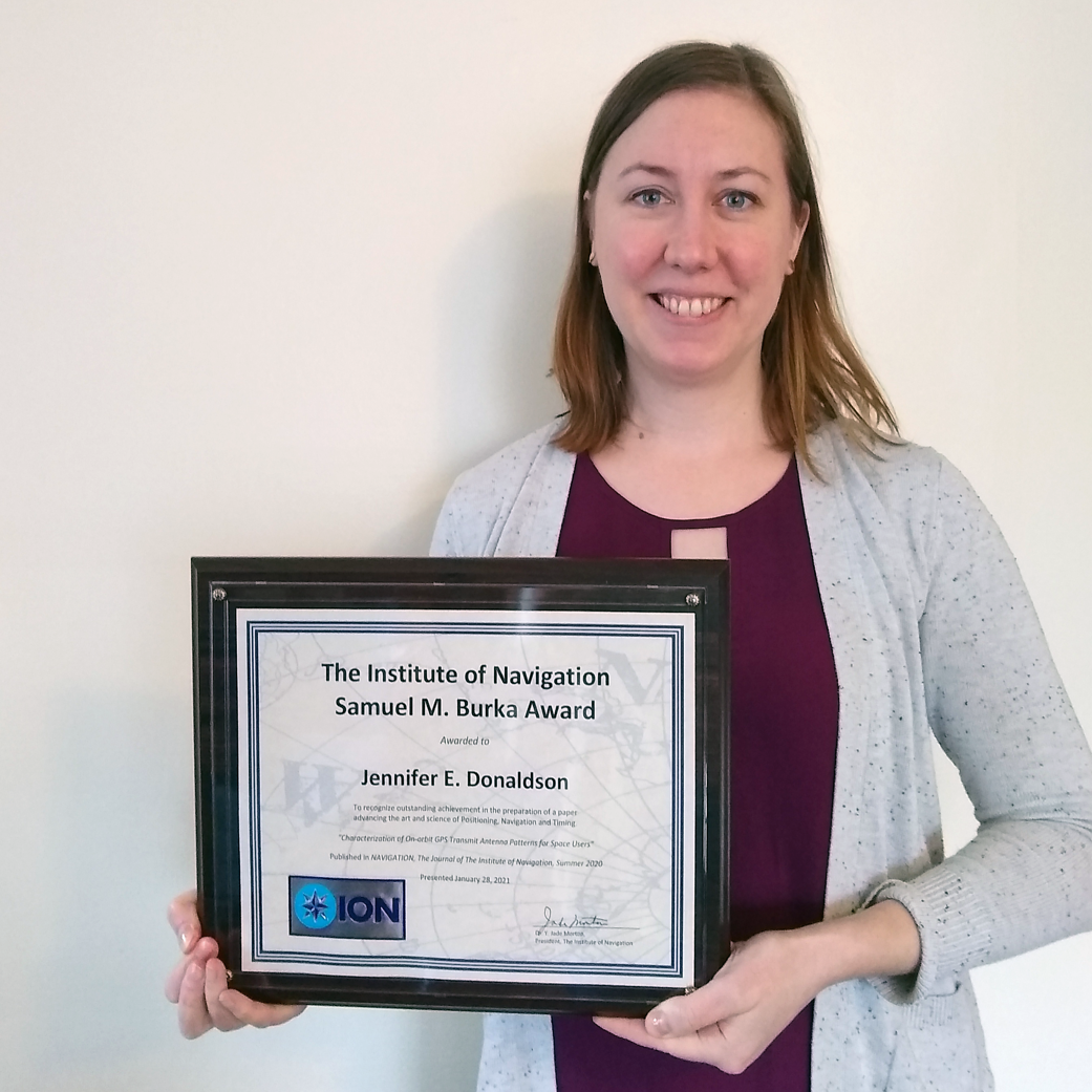 In this photo, GPS ACE engineer Jennifer Donaldson holds the Institute of Navigation's Samuel M. Burka award. 