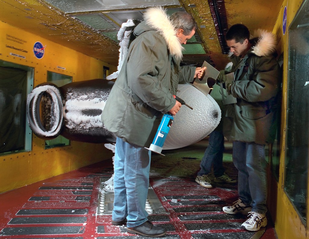 Bell 609 spinner inlet icing model. Technicians taking measurement of ice accretions after an icing test.