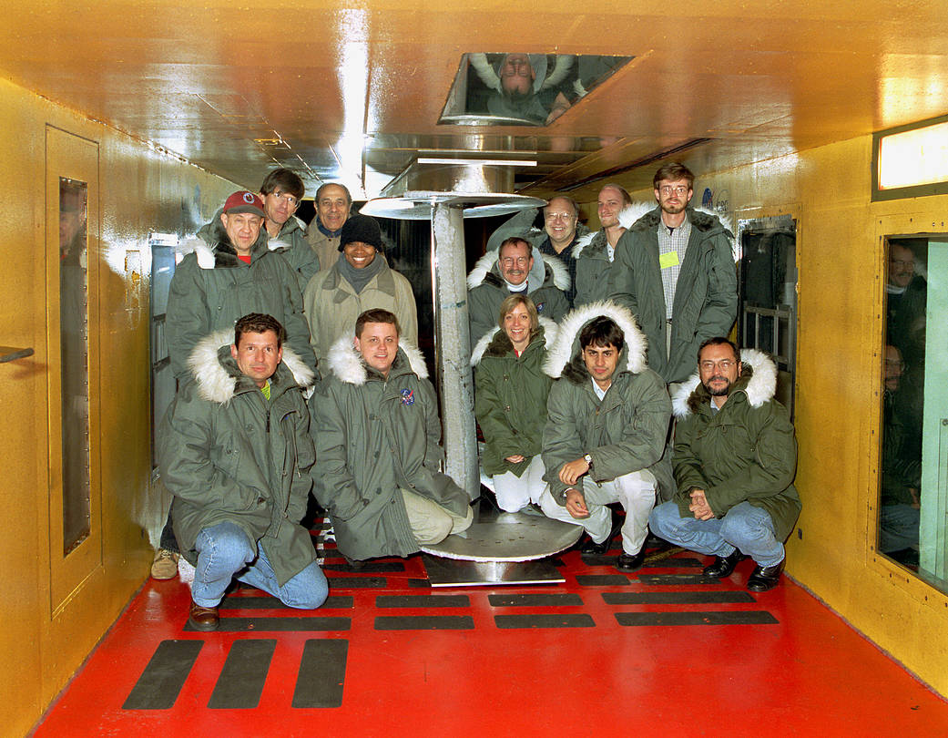Technicians pose with the ERJ-170 airfoil set up for testing the IRT. 