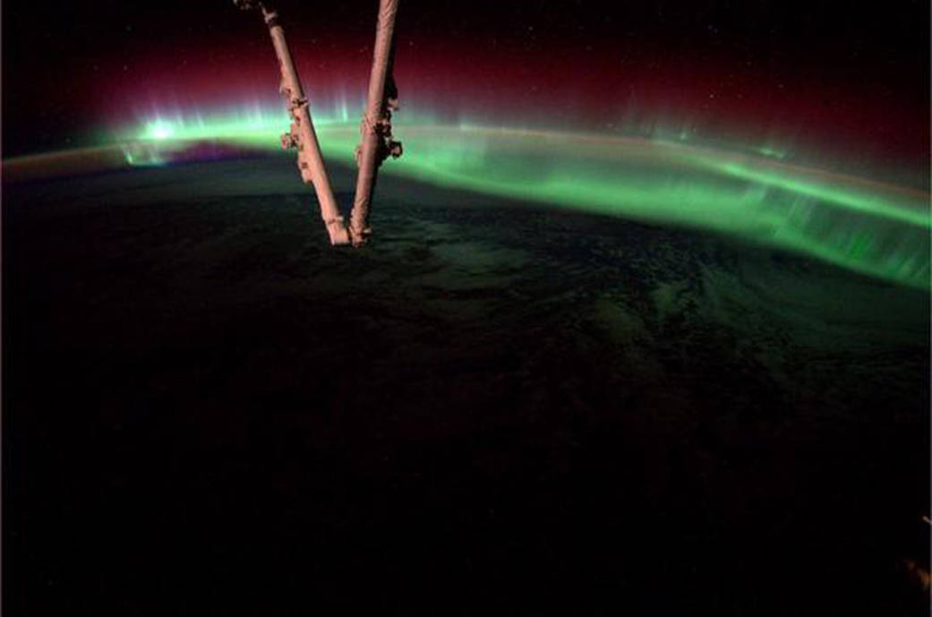 An aurora dances in the atmosphere on Aug. 20, 2014, as the International Space Station flew over North America