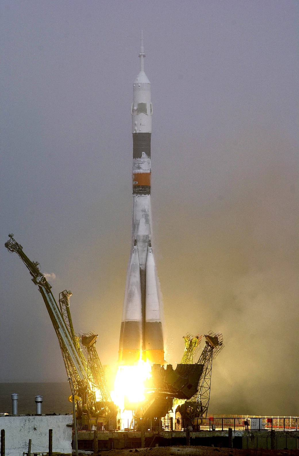 Soyuz spacecraft liftoff from Baikonur Cosmodrome in daytime.
