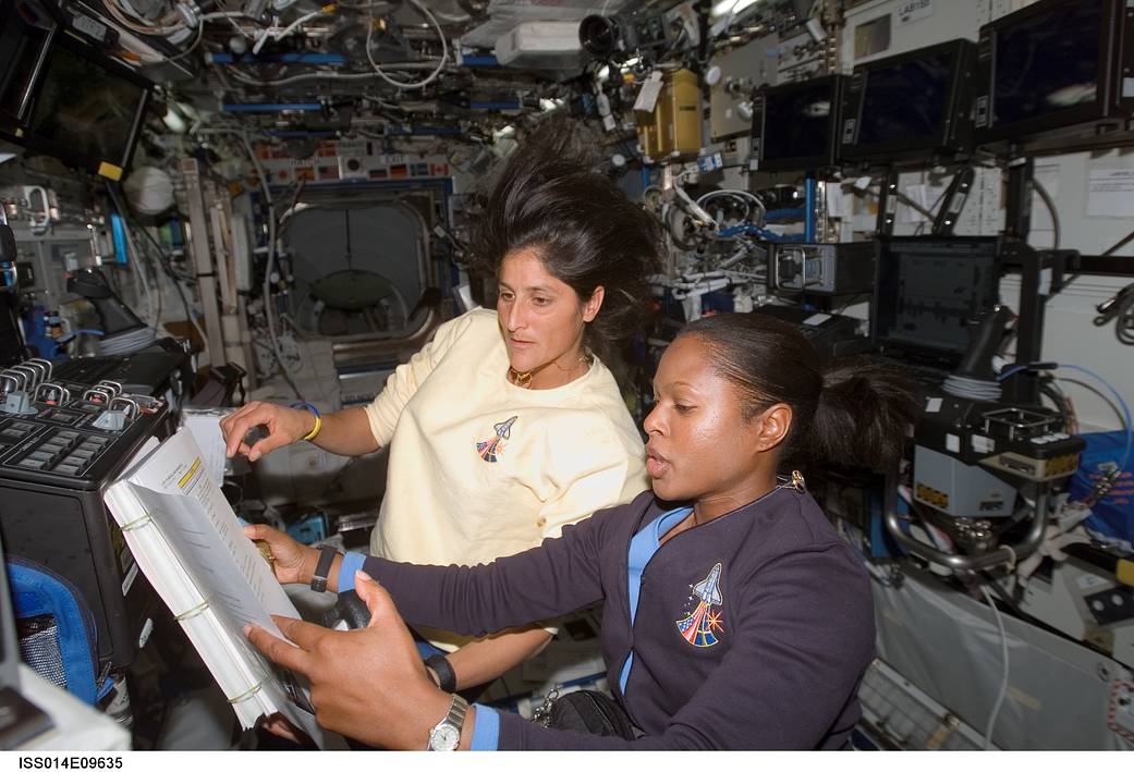 Astronauts Joan E. Higginbotham (foreground), STS-116 mission specialist, and Sunita L. Williams, Expedition 14 flight engineer