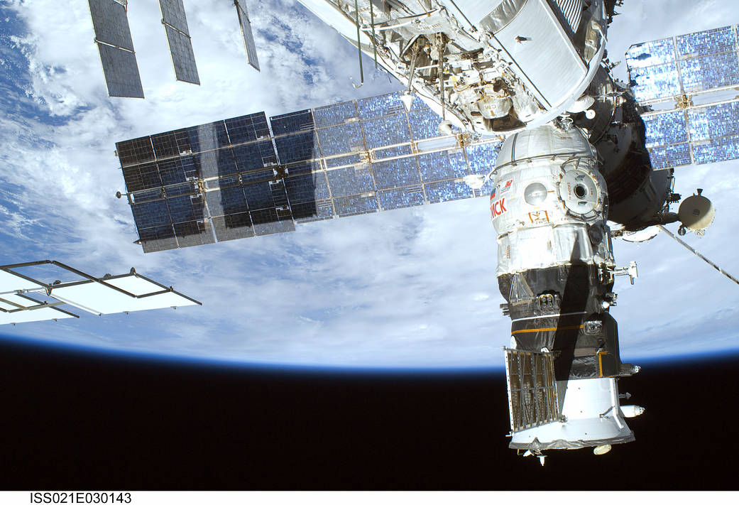 The newly-arrived Poisk Mini-Research Module-2 is seen docked to the space station