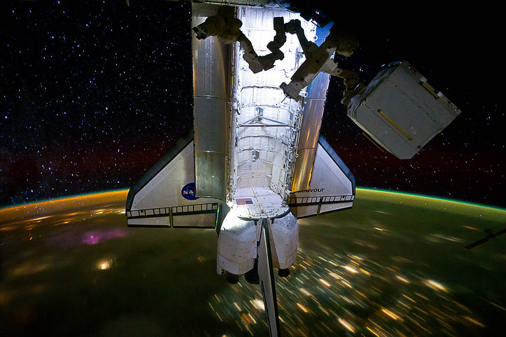 Shuttle Endeavour with Earth at night visible below