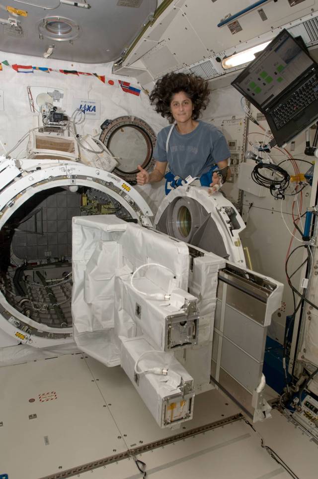 American Astronaut Sunita Williams from Expedition 33 floats next to the J-SSOD containing TechEdSat-1