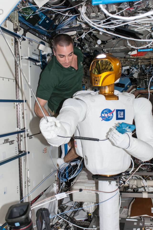 Astronaut Chris Cassidy with Robonaut