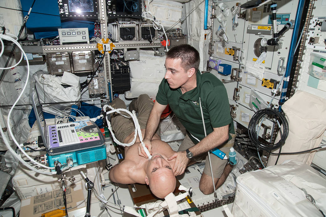 ISS crewmembers perform an ultrasound for the Spinal Ultrasound Investigation
