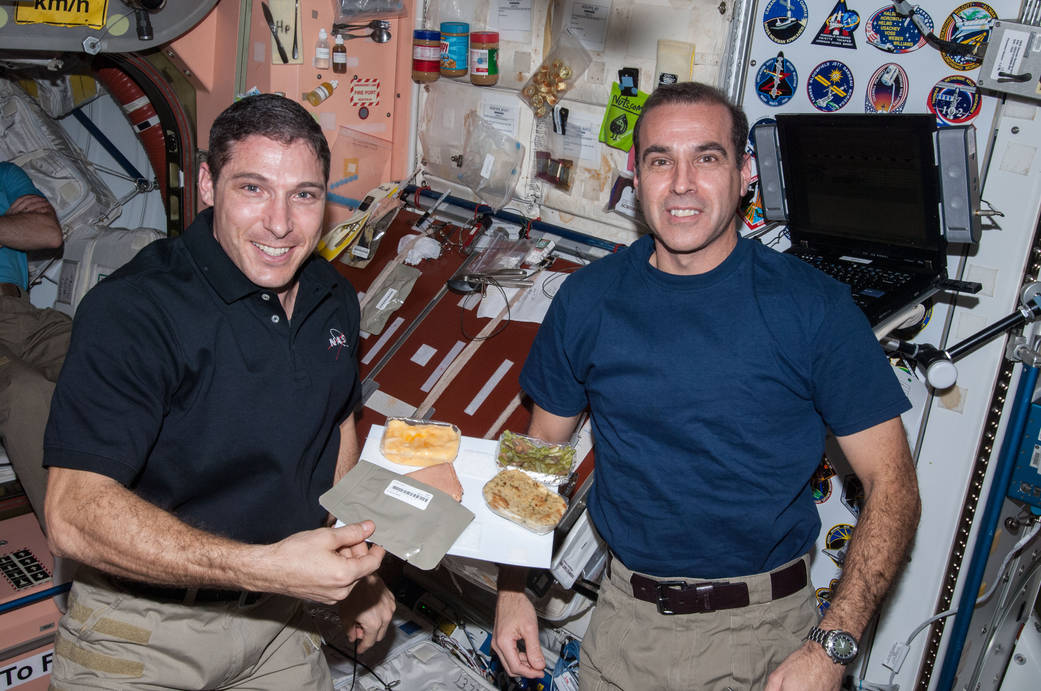 Michael Hopkins and Rick Mastracchio Both Enjoy a Thanksgiving Meal