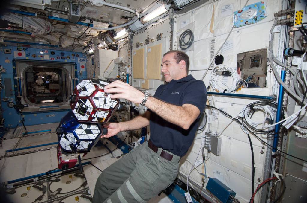 Astronaut Rick Mastracchio works with SPHERES