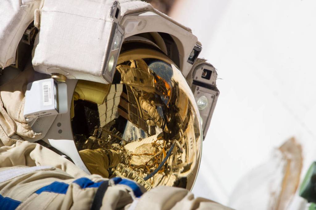 Spacesuit Helmet Reflects Station Spacewalk