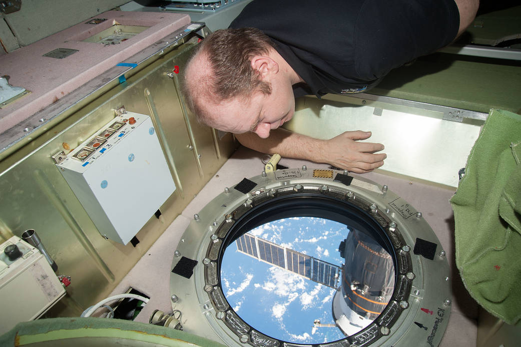 Oleg Kotov Looks Through an Earth-Facing Window