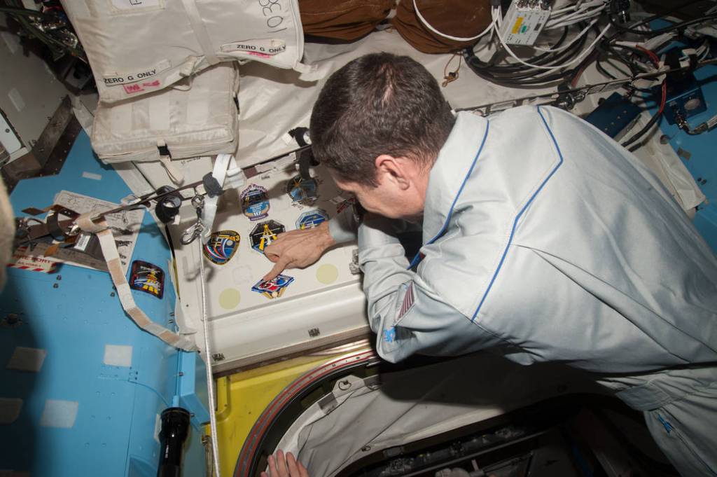 Mike Hopkins Affixes his Mission Decal