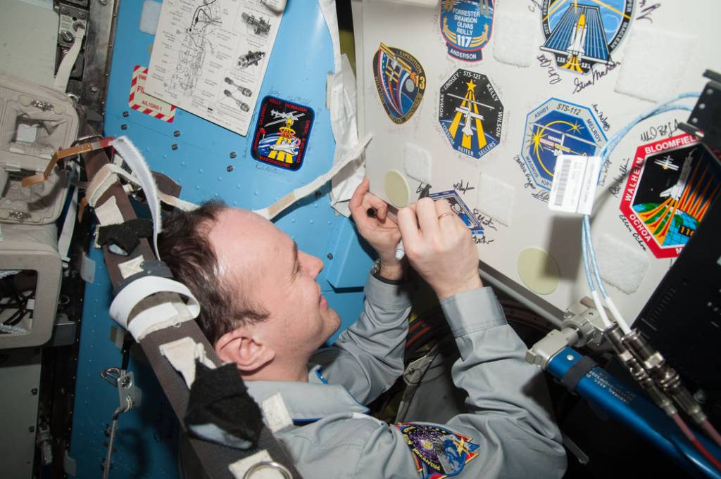 Sergey Ryazanskiy Signs a Spot on a Wall