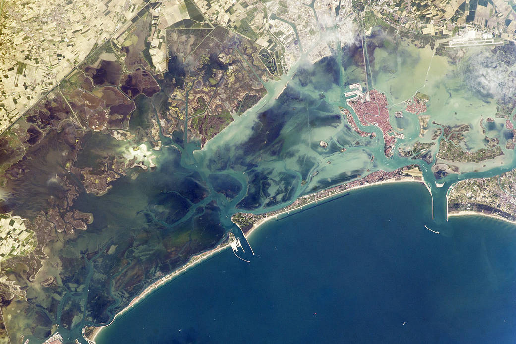 A narrow barrier island protects the Lagoon of Venice from storm waves in the northern Adriatic Sea, and breakwaters protect inl