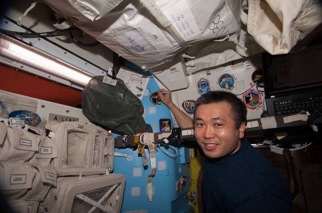 Koichi Wakata Places Crew Patch on Quest Airlock