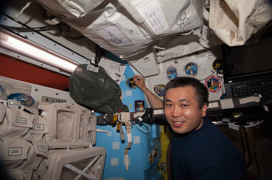 Koichi Wakata Places Crew Patch on Quest Airlock