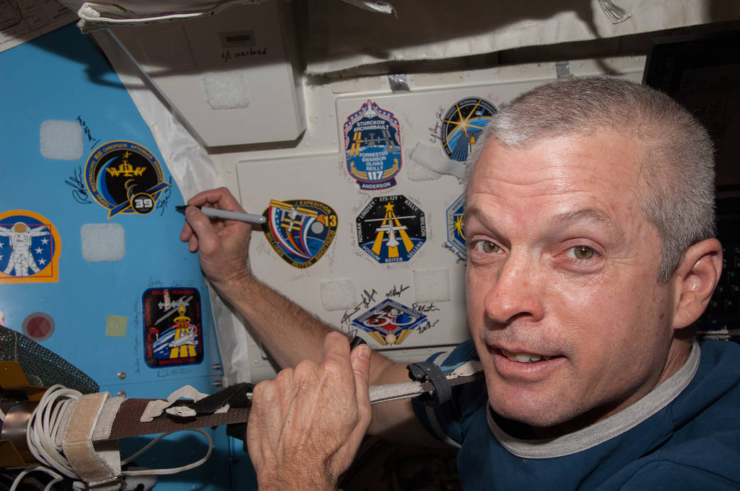 Steve Swanson Signs Wall on Quest Airlock