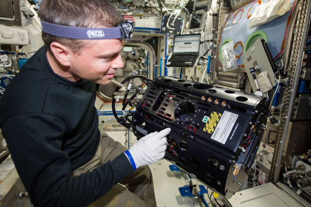 NASA Astronaut Reid Wiseman With Multi-user Drop Combustion Apparatus