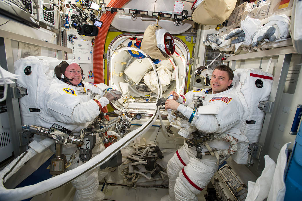 Barry Wilmore and Reid Wiseman in spacesuits preparing for an upcoming spacewalk