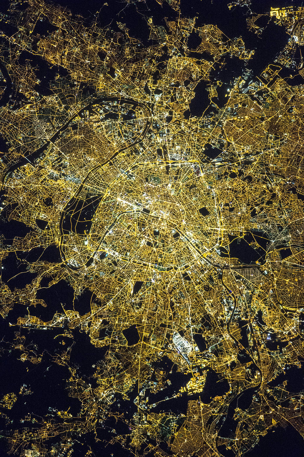Nighttime view of the city of Paris from low Earth orbit showing bright streetlights