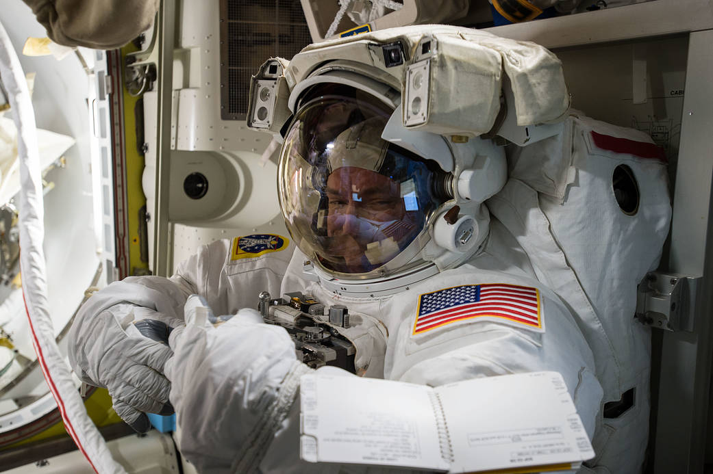Astronaut Scott Kelly in spacesuit during fit check inside space station