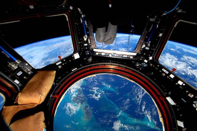 View of Earth through the space station's Cupola windows taken by the Expedition 46 crewmember, Scott Kelly.