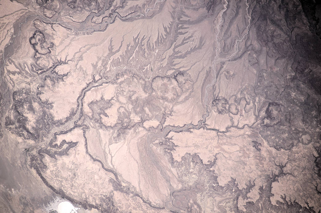 Intricate lines of water flowing across desert