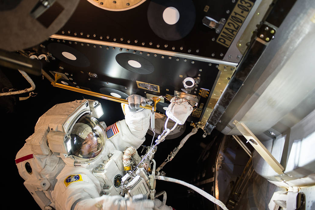Astronaut Jeff Williams in spacesuit working outside space station