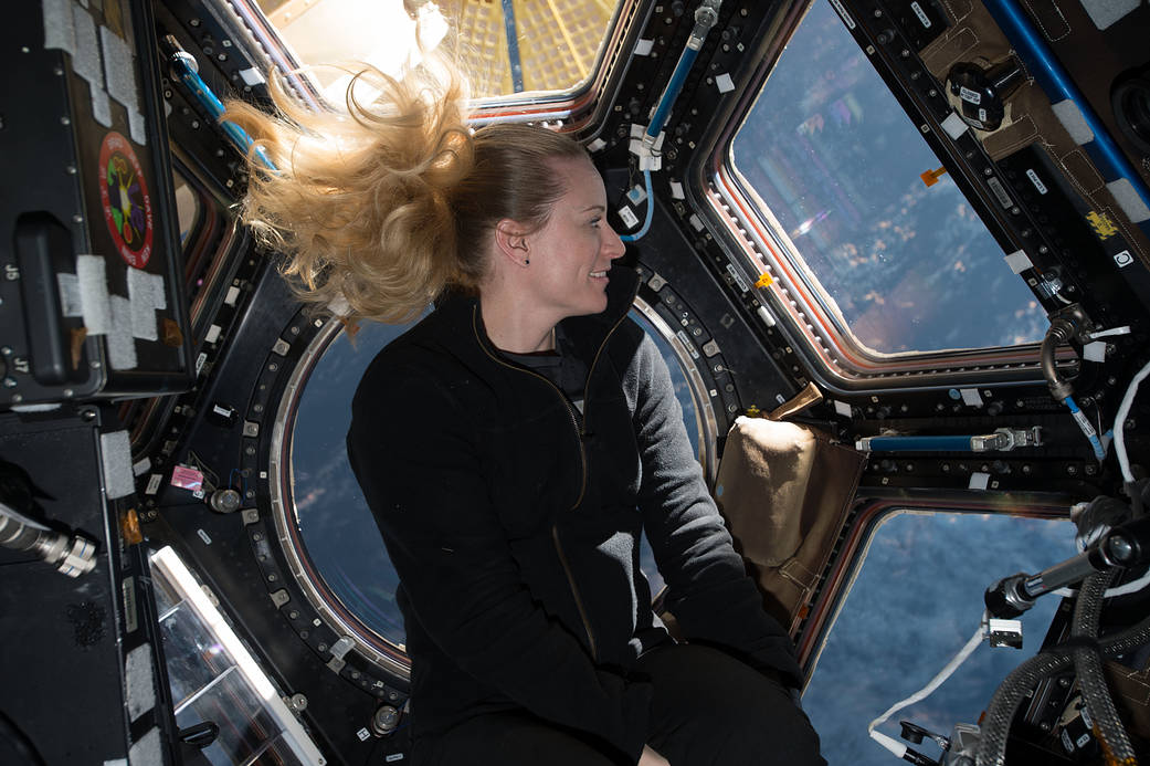 NASA astronaut Kate Rubins in front of the windows in the International Space Station’s cupola module in 2016