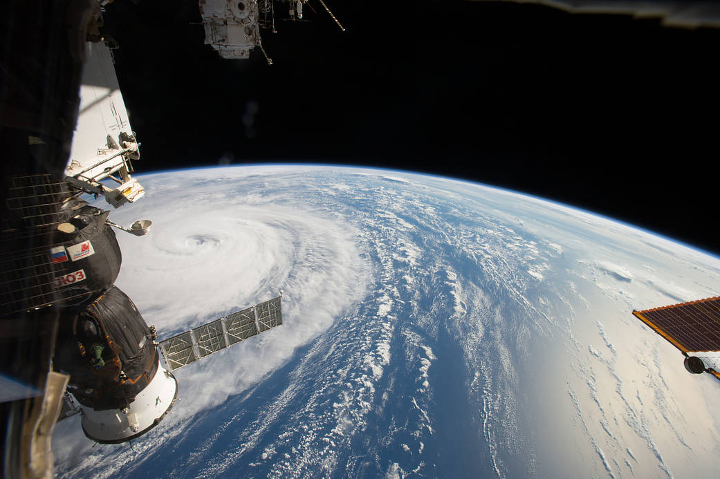 Super typhoon photographed from low Earth orbit with Soyuz spacecraft in left of frame