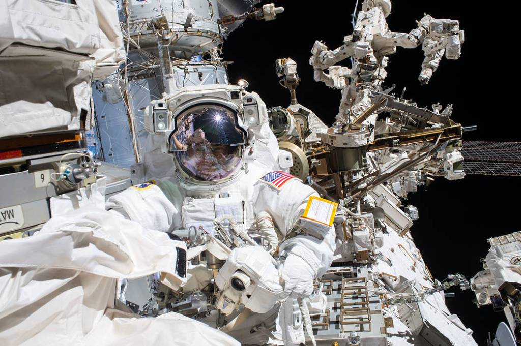 Spacewalker Mark Vande Hei works on the Canadarm2 robotic arm