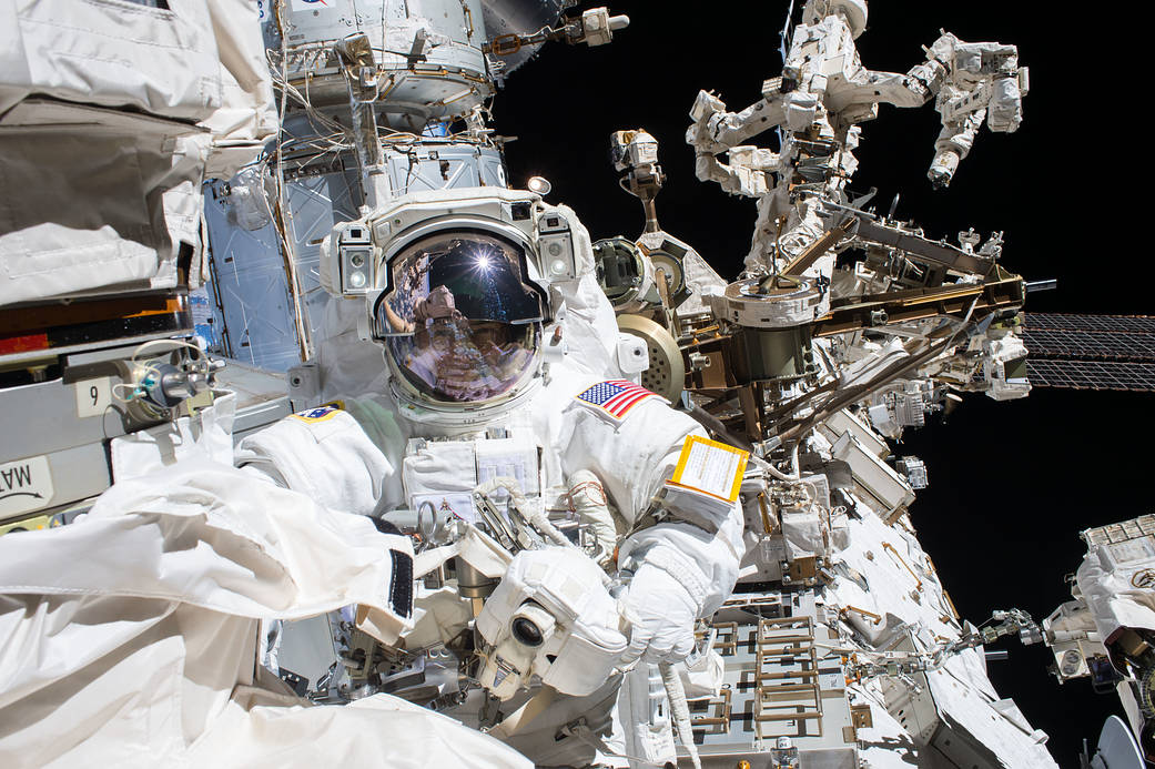Spacewalker Mark Vande Hei works on the Canadarm2 robotic arm
