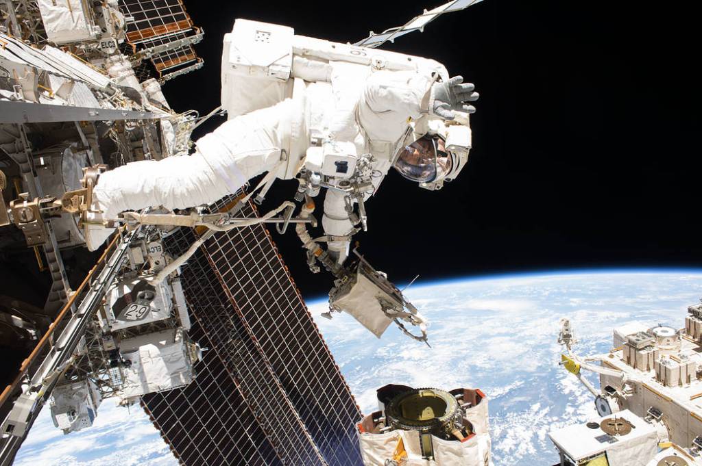 Spacewalker Mark Vande Hei works on the Canadarm2 robotic arm
