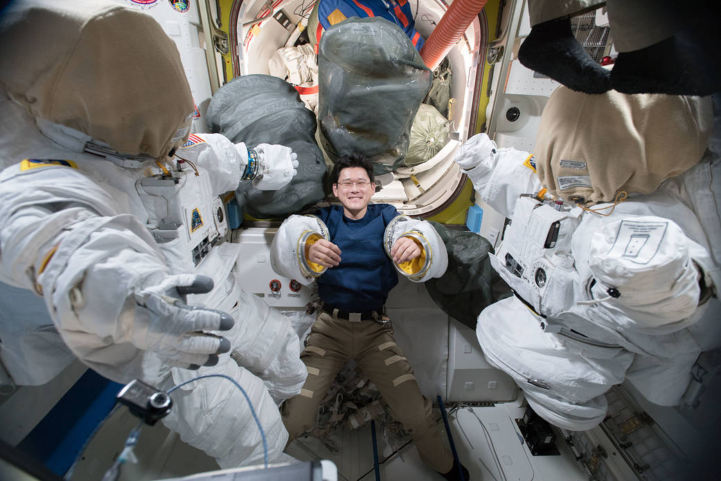 Astronaut Norishige Kanai Tries on a Pair of Spacesuit Sleeves