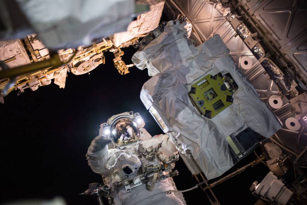 Spacewalker Mark Vande Hei works on the Canadarm2 robotic arm