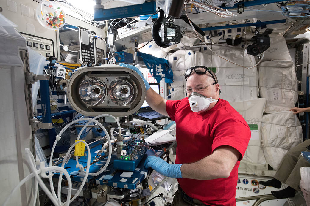 NASA astronaut Scott Tingle prepares gear for an upcoming spacewalk