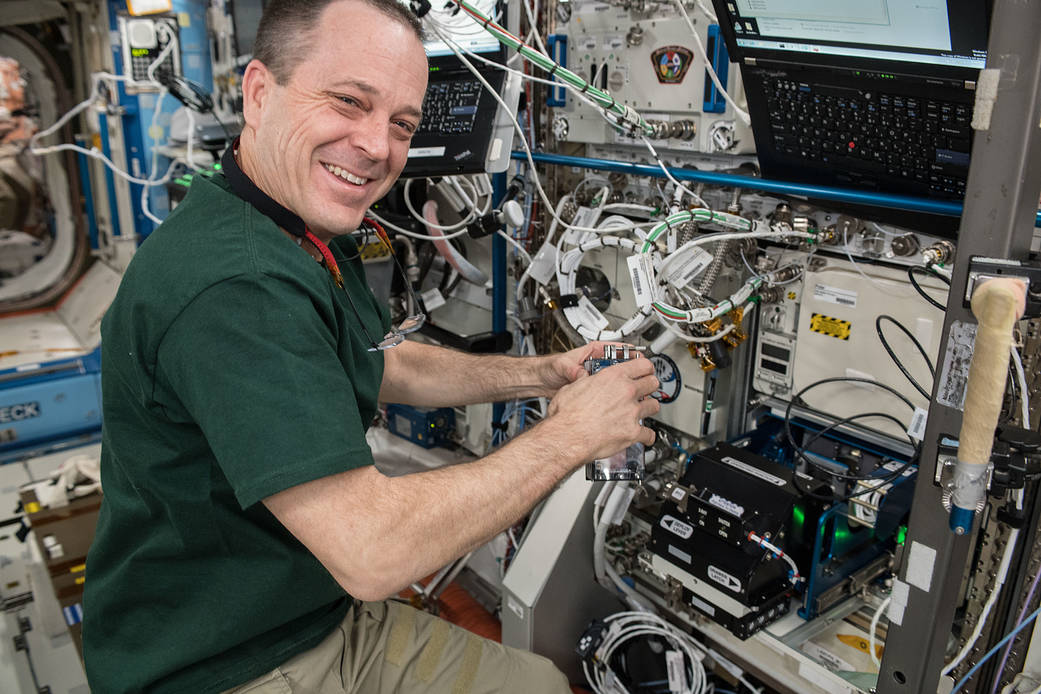 NASA astronaut Ricky Arnold calibrates the Bone Densitometer