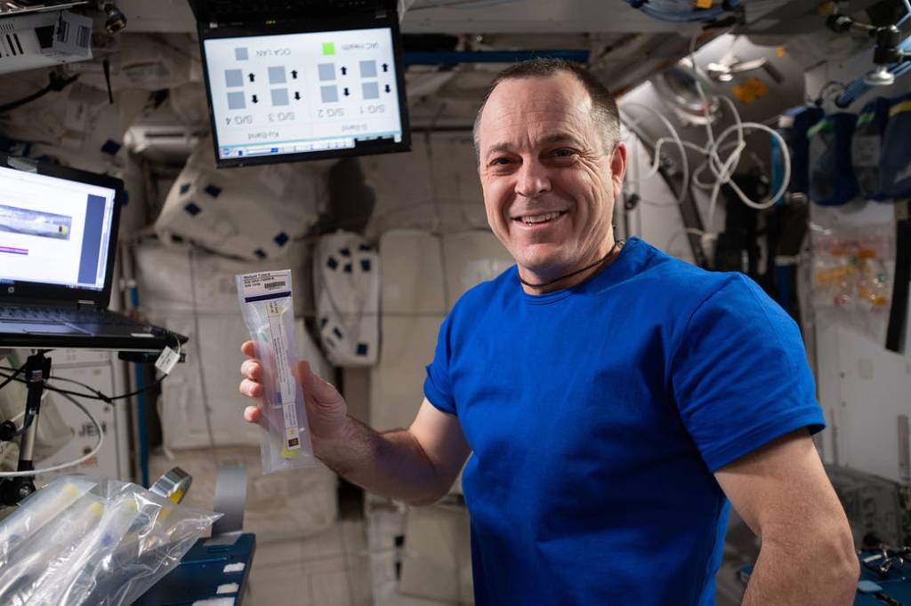 Expedition 56 Flight Engineer Ricky Arnold works with a student-designed experiment