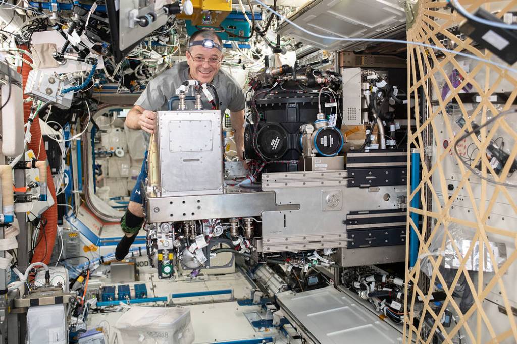NASA astronaut Ricky Arnold works with the Combustion Integrated Rack
