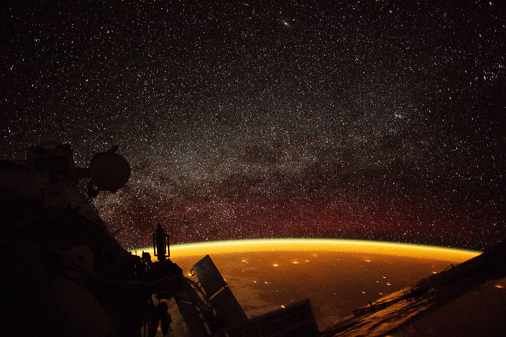orange hue enveloping Earth is known as airglow—diffuse bands of light that stretch 50 to 400 miles into our atmosphere