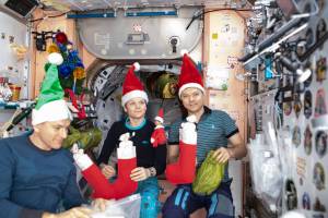 The Expedition 58 crew opens stockings on Christmas Day